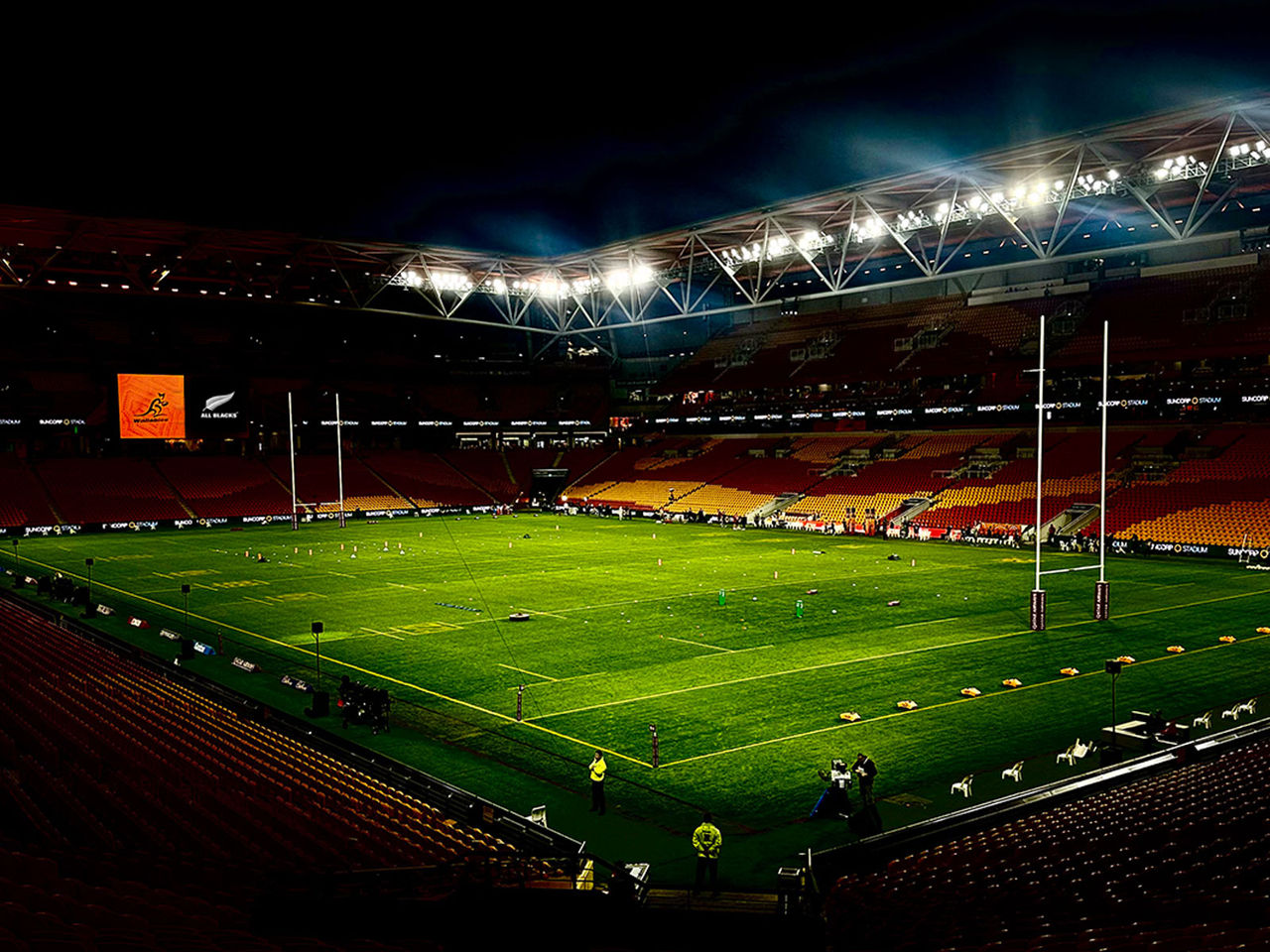 Suncorp Stadium at night with Wallabies and All Blacks on the screen