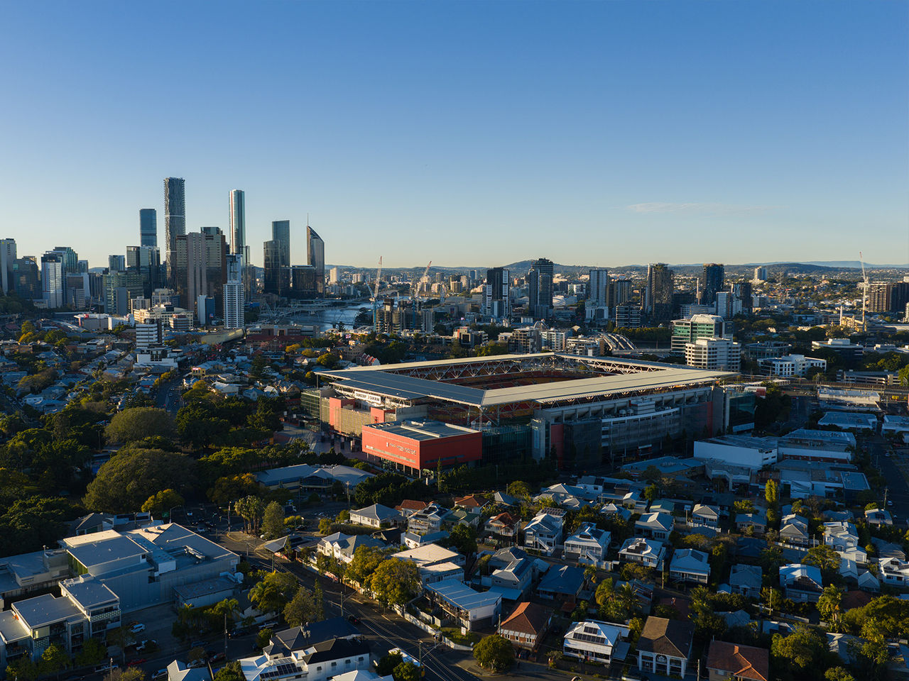 An aerial image looking over Suncorp Stadium and Brisbane City from the North West at dawn as the sun rises
