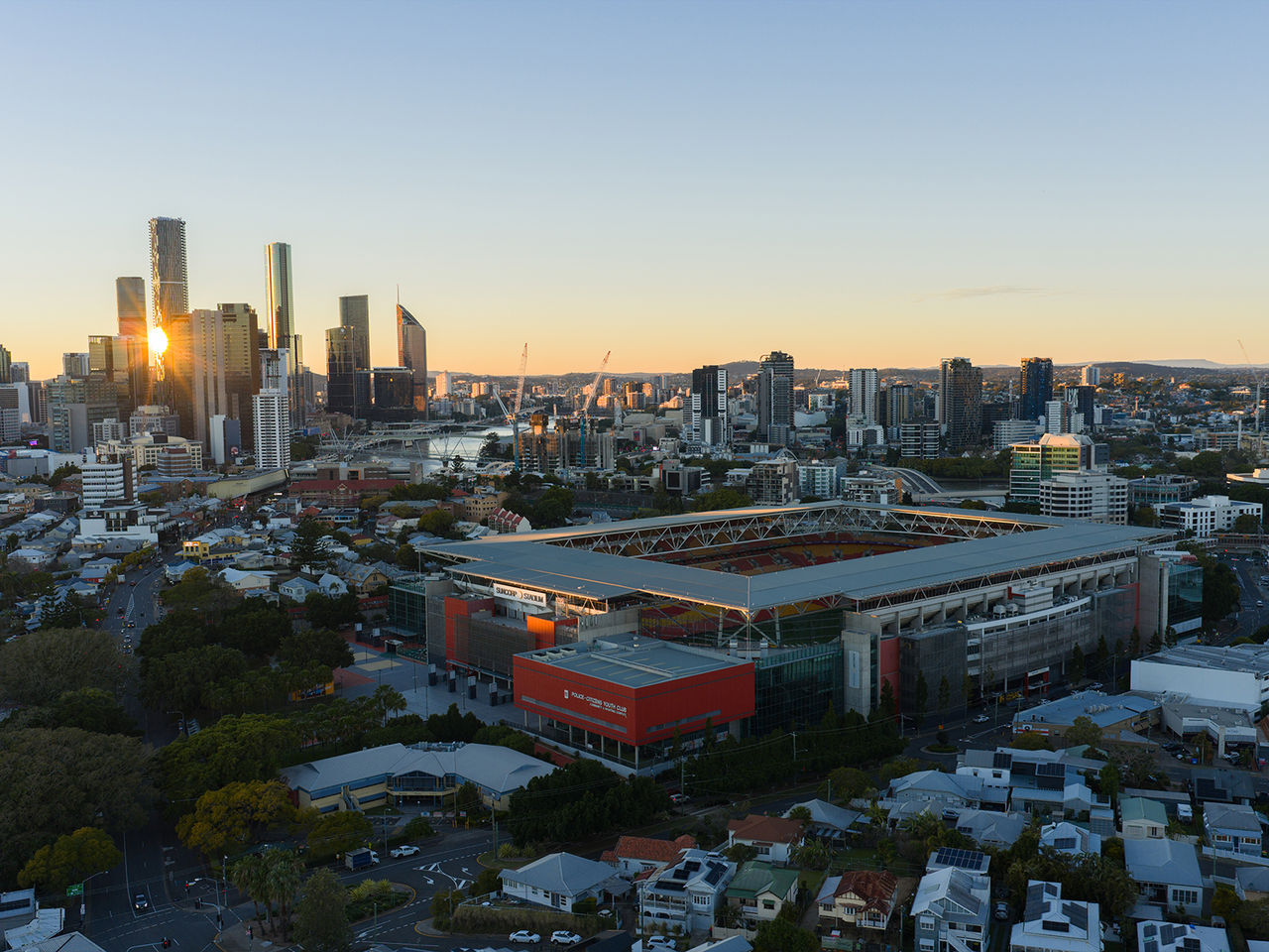 An aerial image looking over Suncorp Stadium and Brisbane City from the North West at dawn as the sun rises