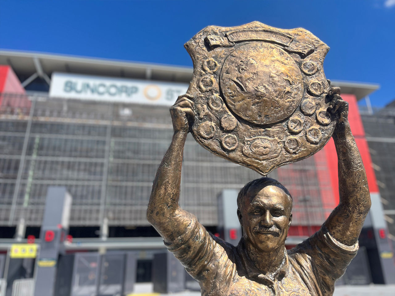 A close up of the top half of the Wally Lewis Statue in front of Suncorp Stadium