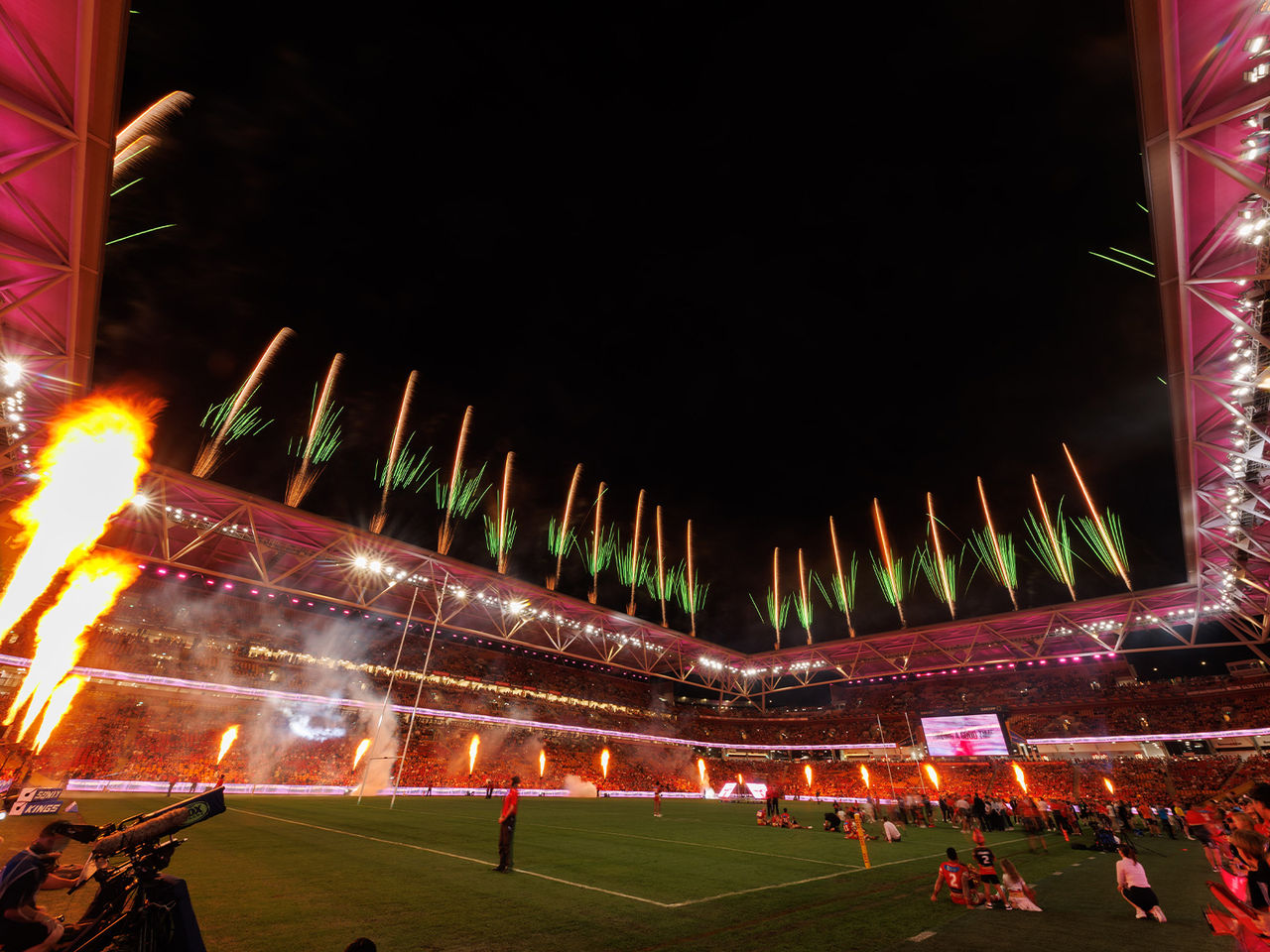 Fireworks and flames light up the night sky at Suncorp Stadium at the end of a NRL game as part of Brisbane Riverfire