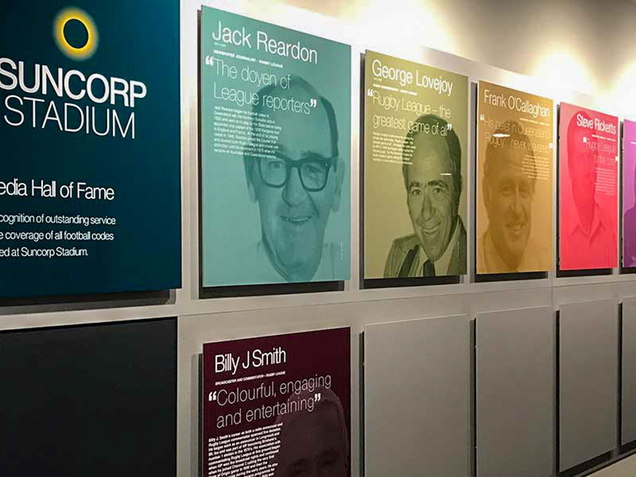 Image showing the Suncorp Stadium Media Hall of Fame. Depicts multiple coloured plaques on a wall.