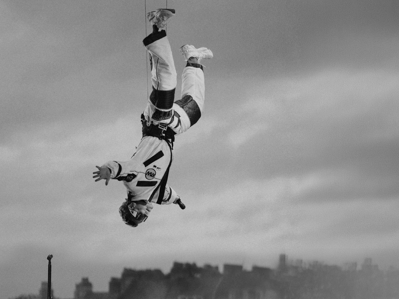 An image of Robbie Williams hanging upside down