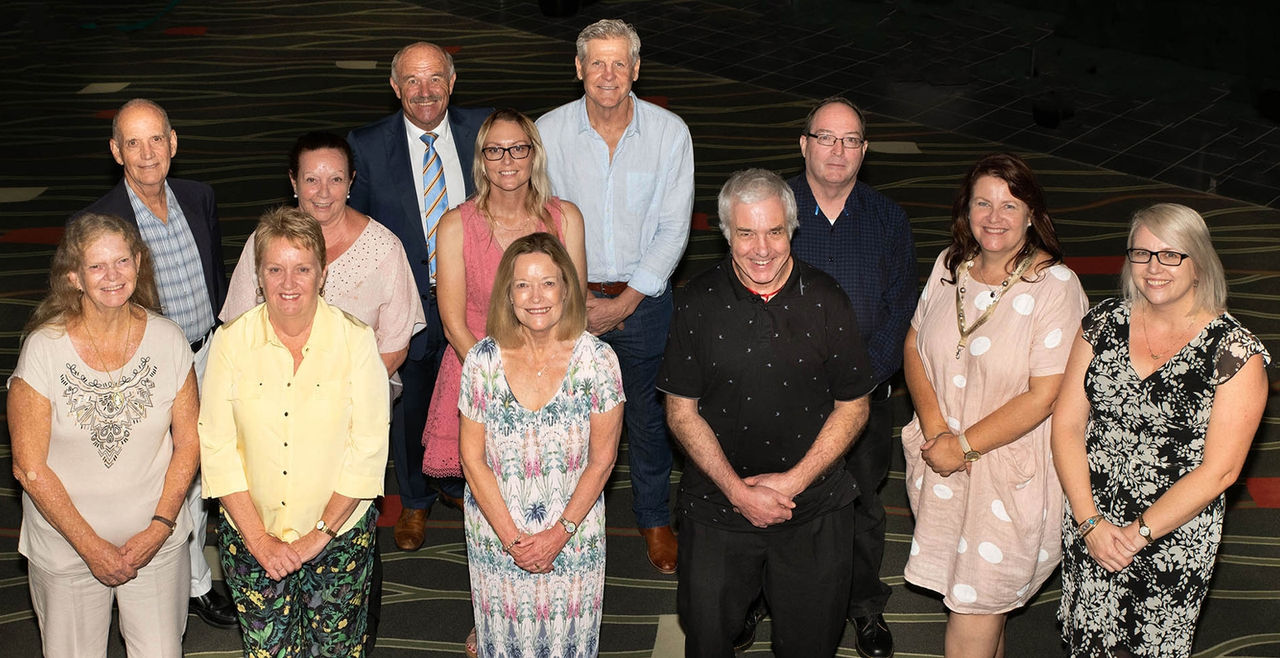Image of 15 Year Anniversary Staff Members with Wally Lewis and Gene Miles.