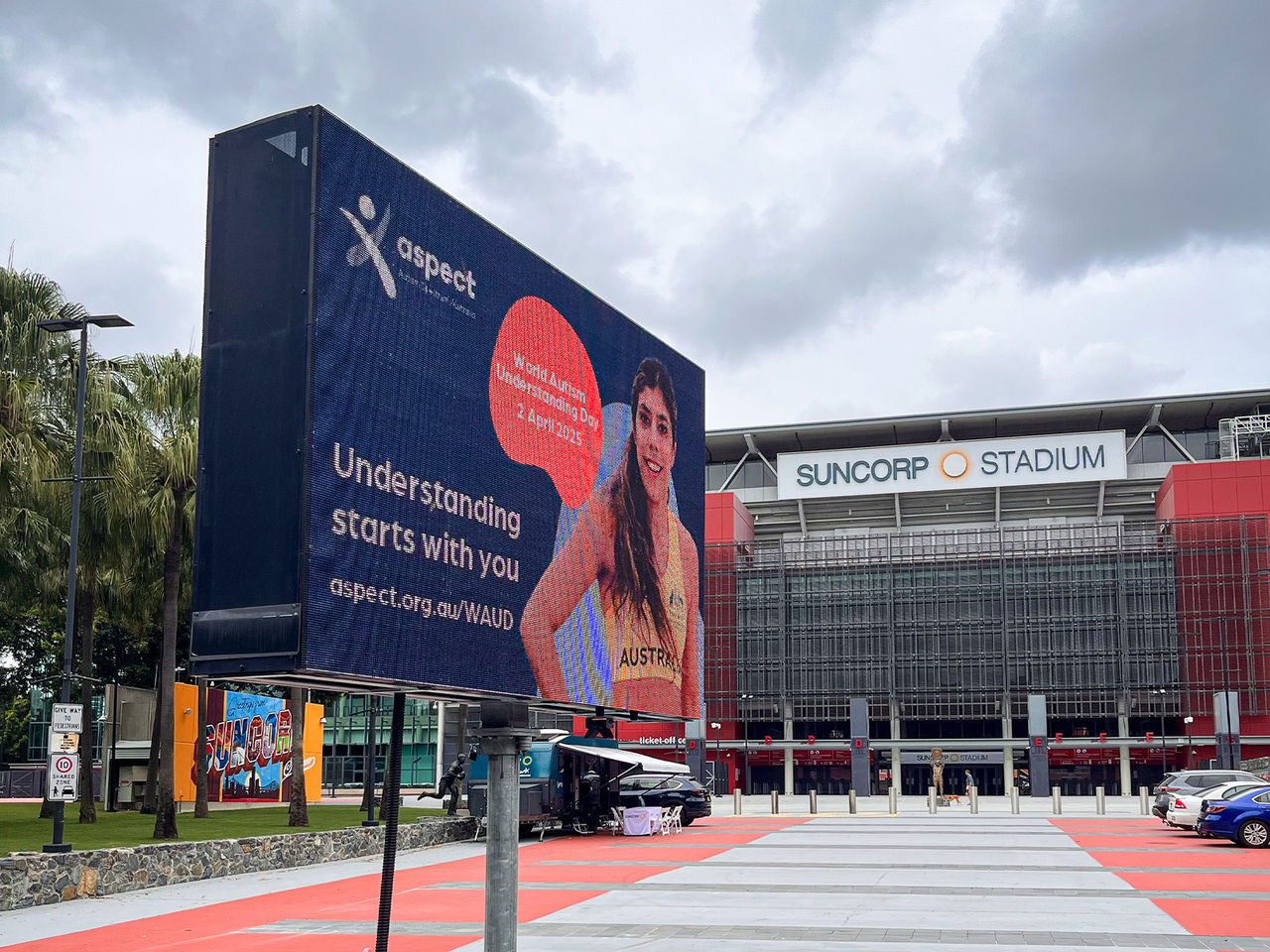 An image of the Suncorp Stadium LED sign on Caxton Street displaying a World Autism Understanding Day Graphic to support Autism awareness and understanding