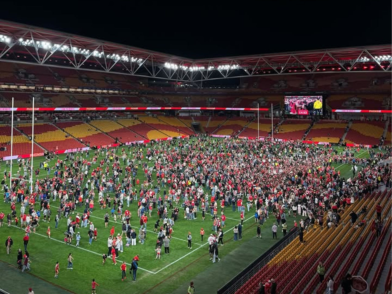 Dolphins fans on the field at Suncorp Stadium