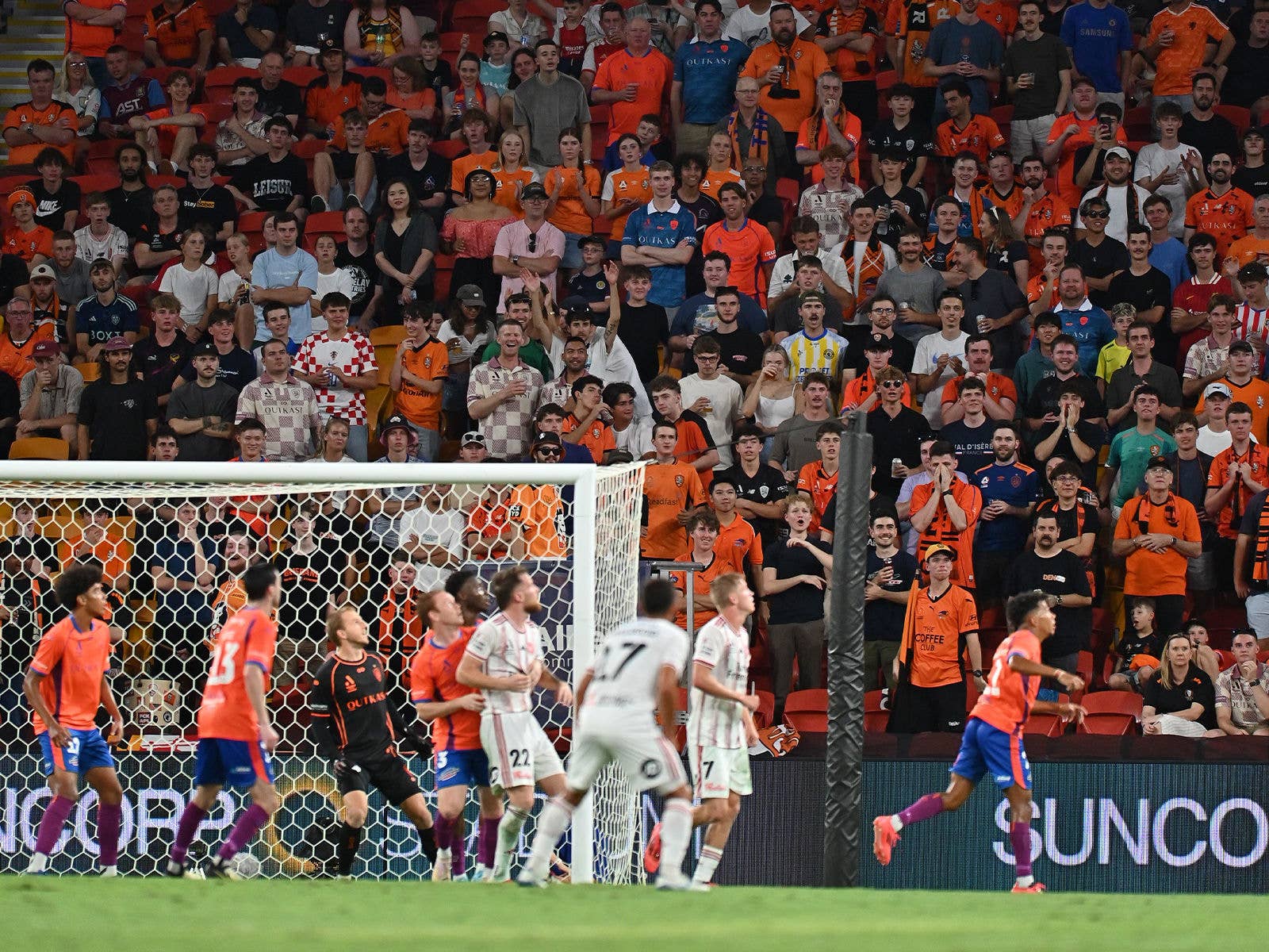 The Brisbane Roar ready to defend a cross with the Den supporters in the background