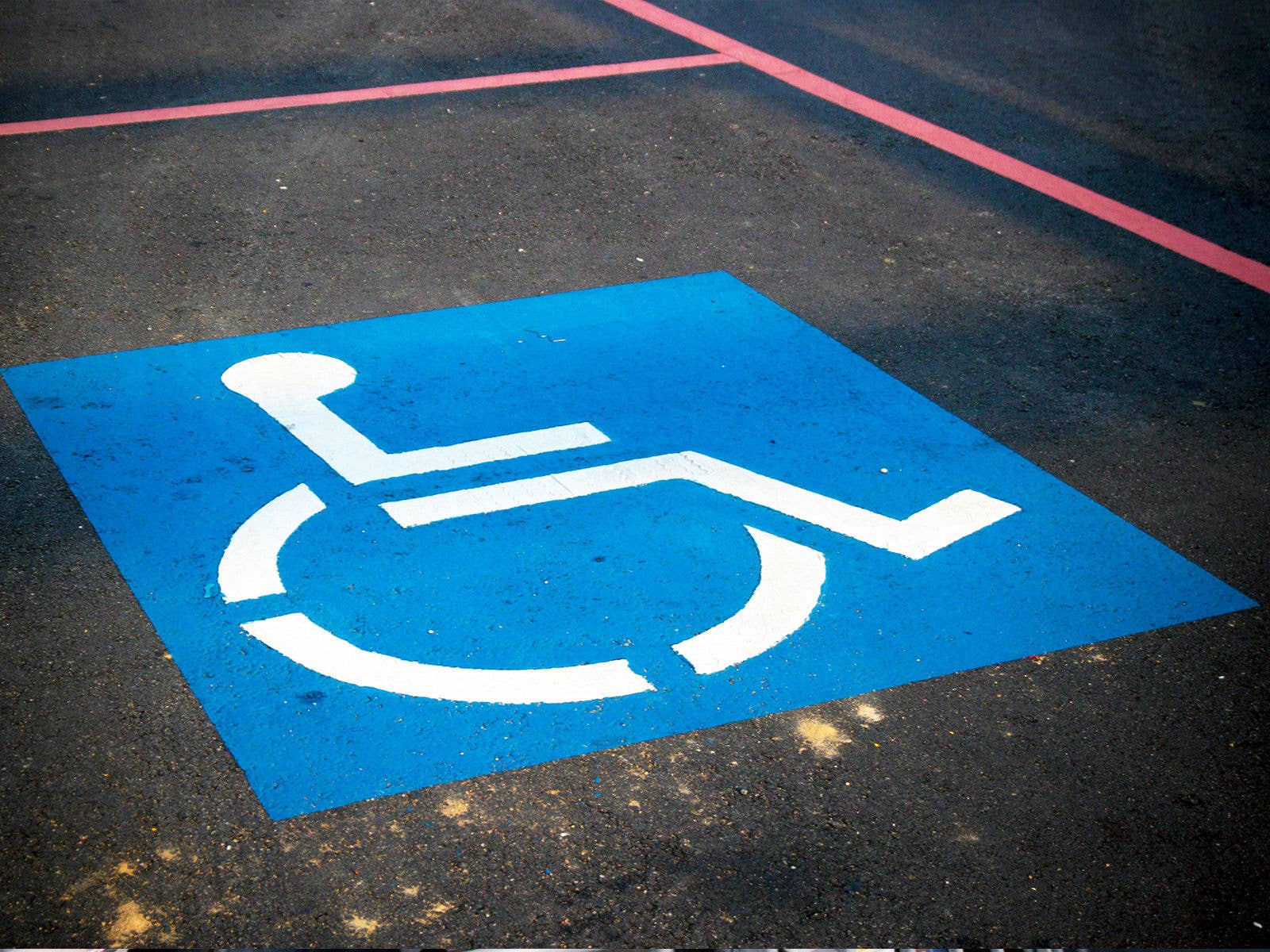 Person with disability icon sign marked on the road parking spot