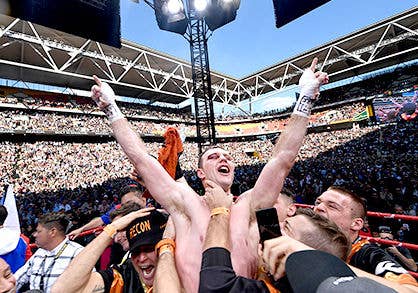 Brisbane’s Jeff Horn celebrating his win in the ring, surrounded by a packed out Suncorp Stadium.