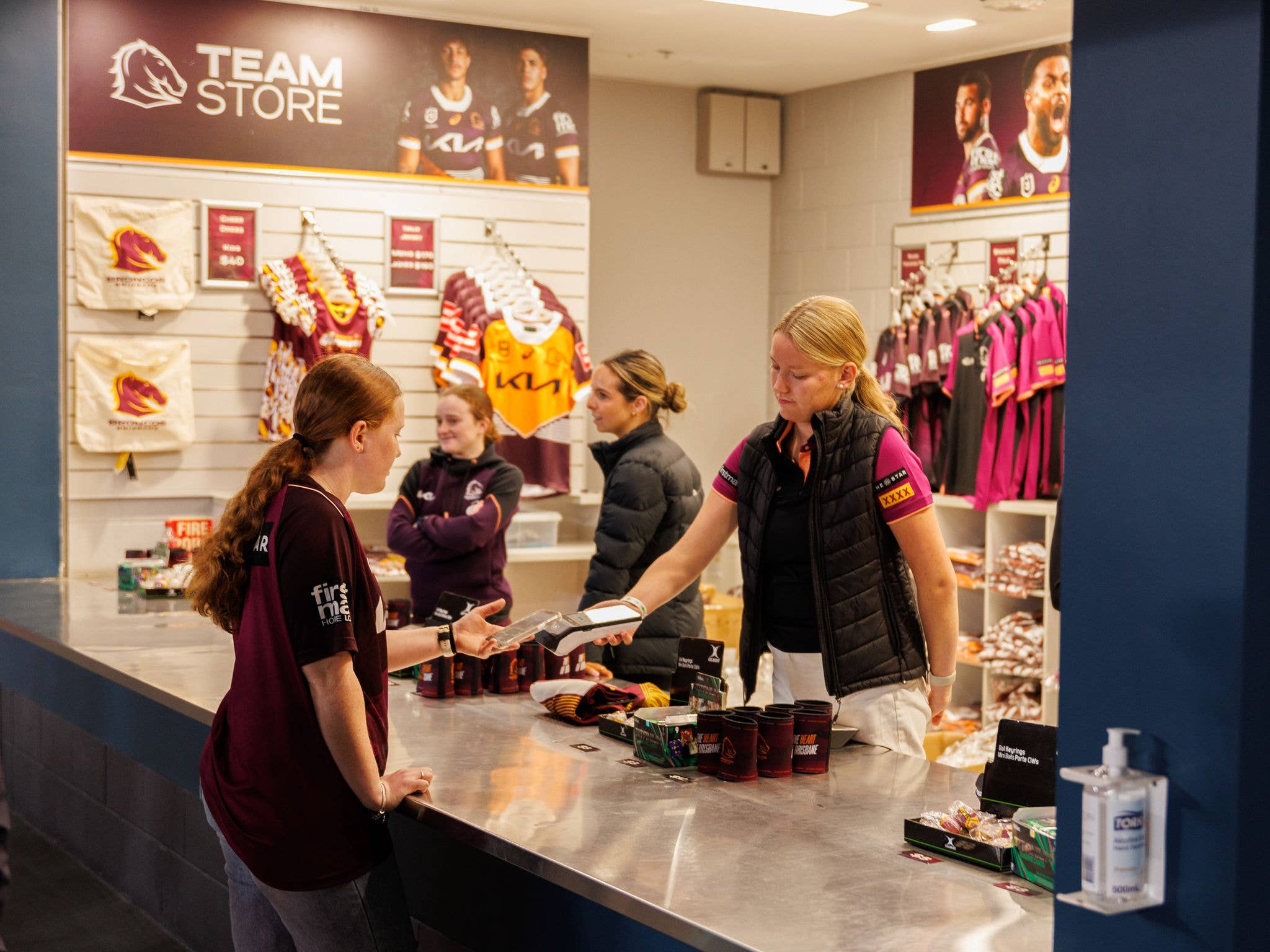 Patron being served whilst purchasing merchandise at the internal team store.