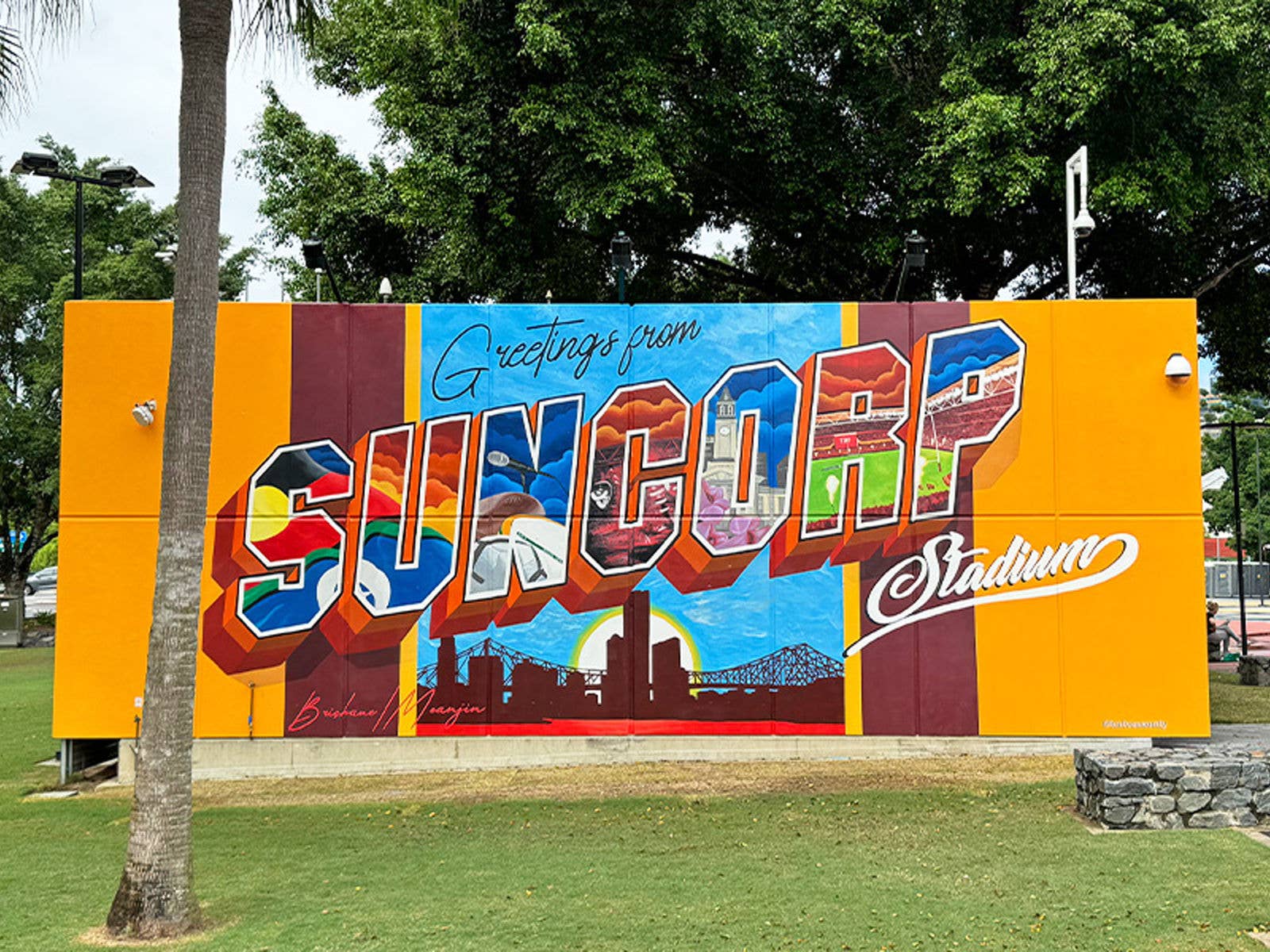 A postcard inspired mural reading Greetings from Suncorp Stadium