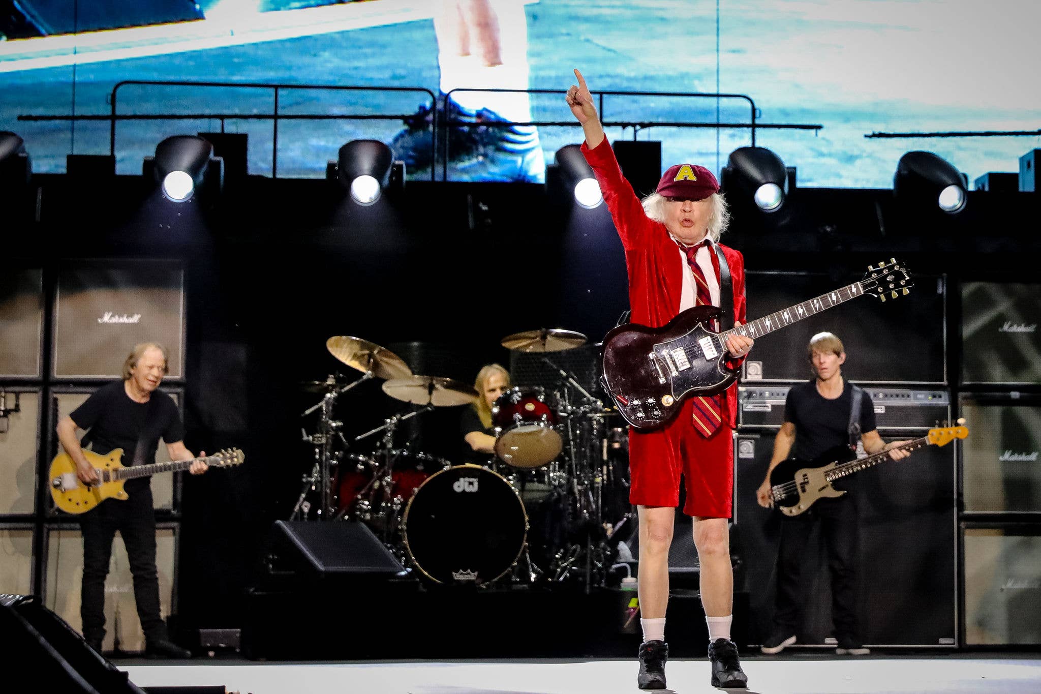 ACDC Press Images An image of an ACDC band member on stage holding up his hand