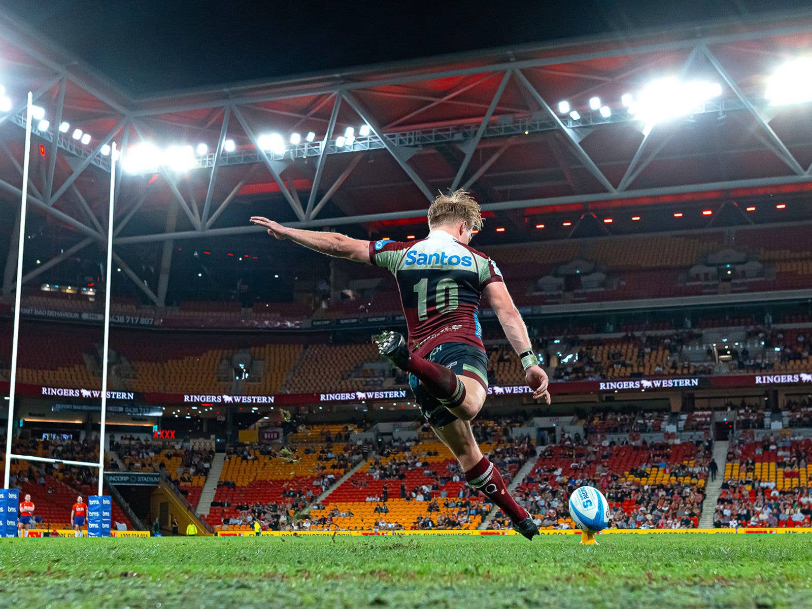 Reds player Tom Lynagh kicking for goal