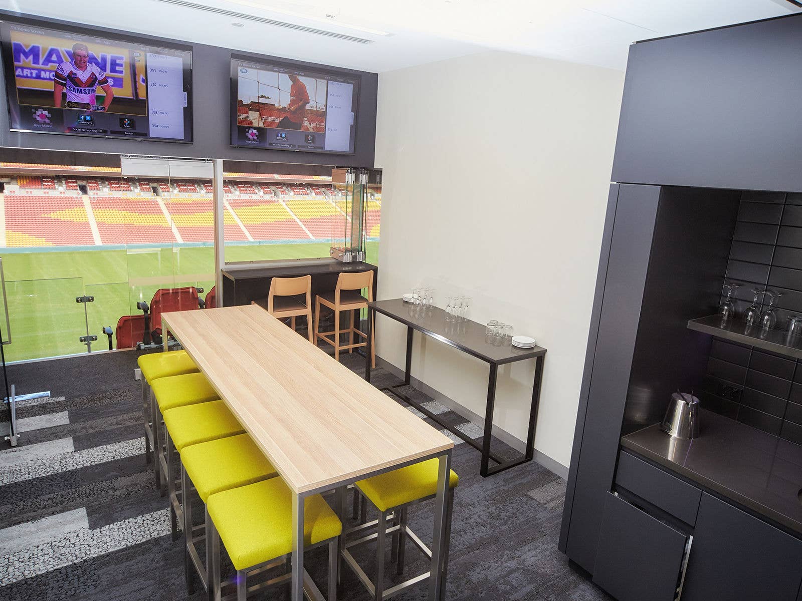 Inside a corporate suite at Suncorp Stadium with the field in the background