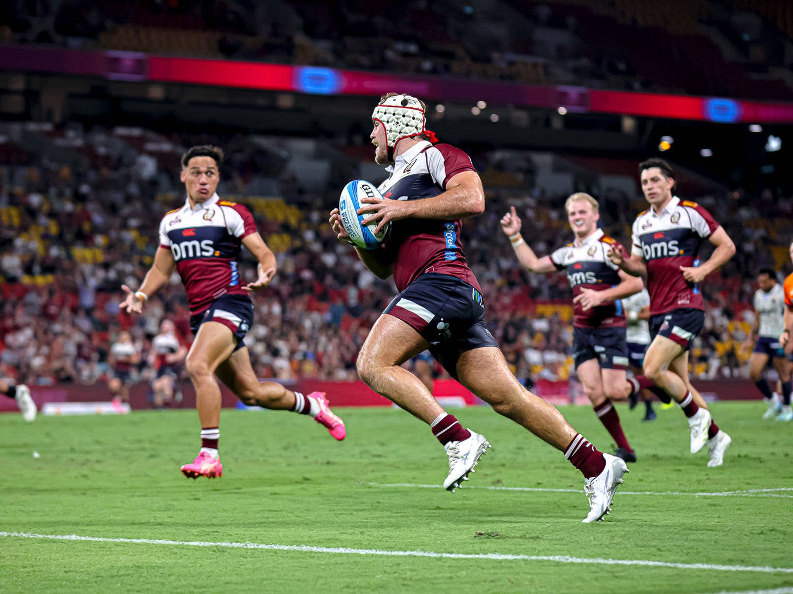 Reds player running to score a try 