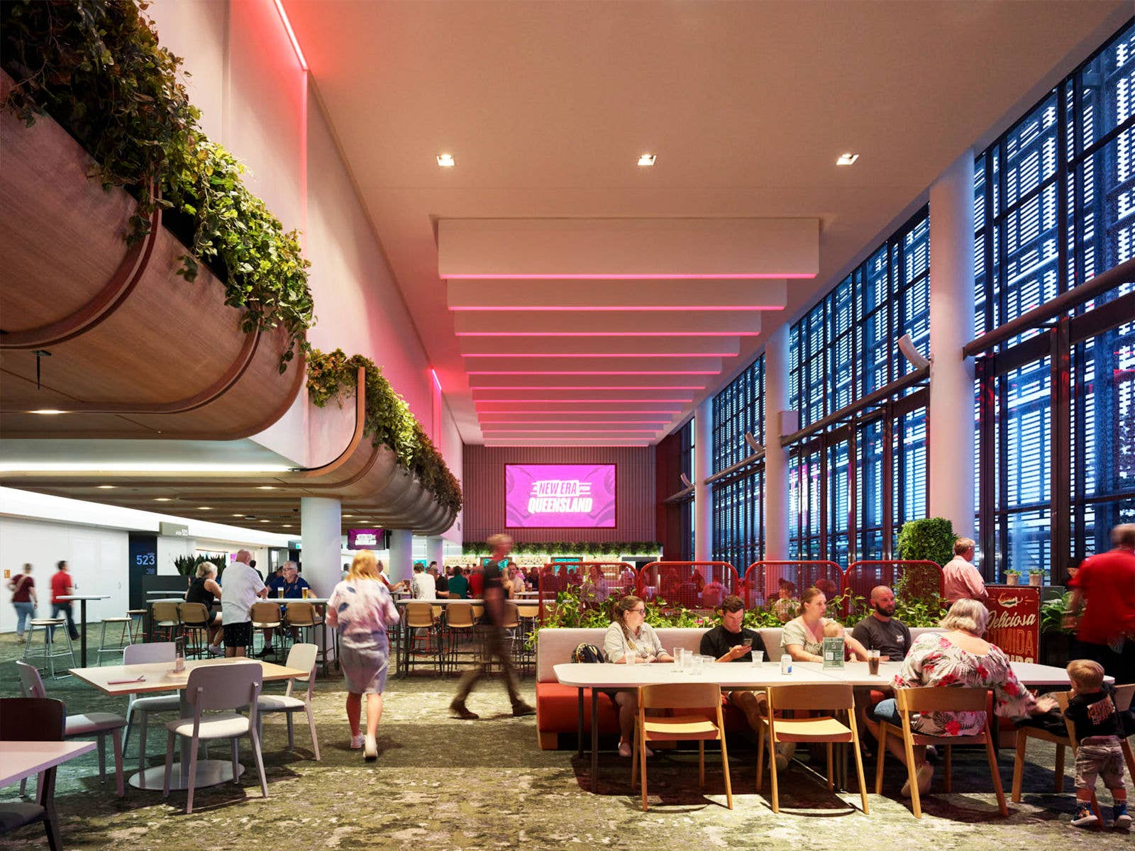 Interval view of Suncorp Stadium's Emerald Lounge during an event. Patrons are sat at tables and graphics are displayed on the big screen in the background.