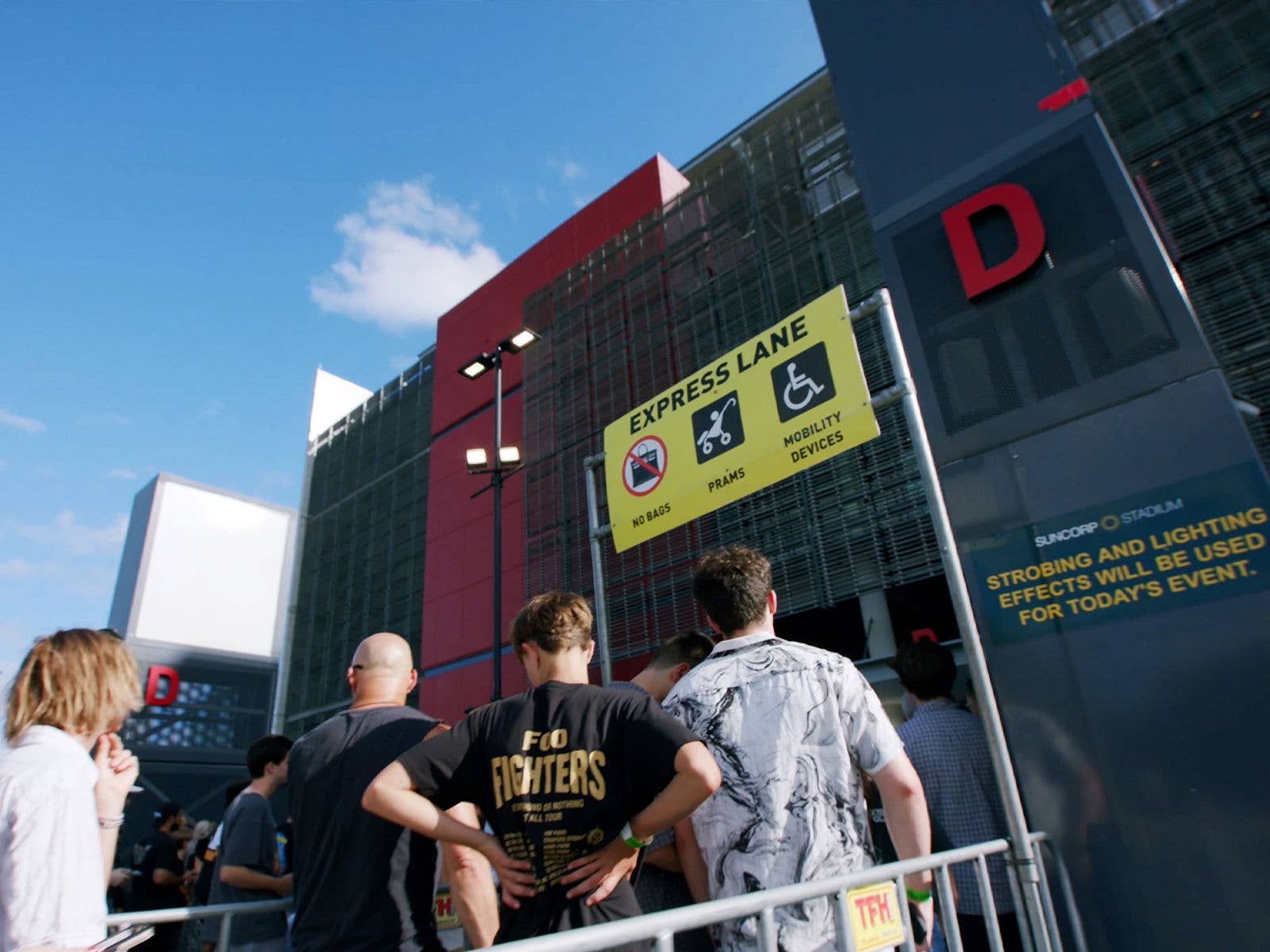 An image of the express lane on the Suncorp Stadium North Plaza at Gate D and people lined up in the lane to enter the venue