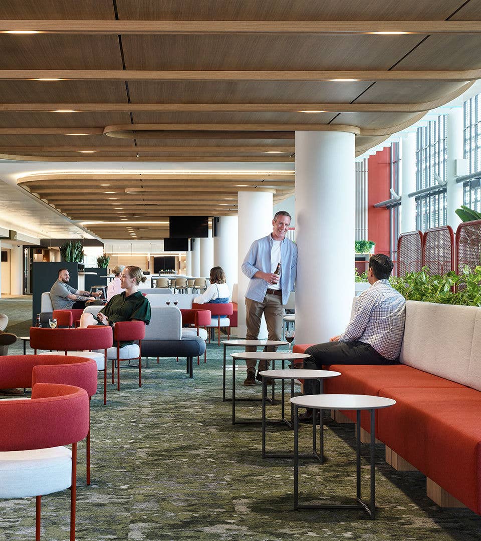 People mingling and enjoying talking in the Suncorp Stadium Members Emerald Lounge