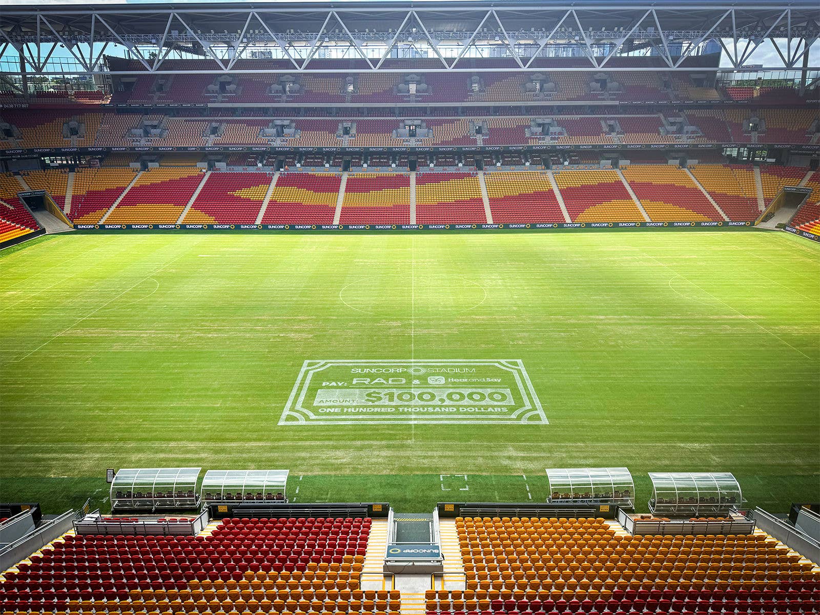 A large white $100000 Cheque painted on the Suncorp Stadium field 