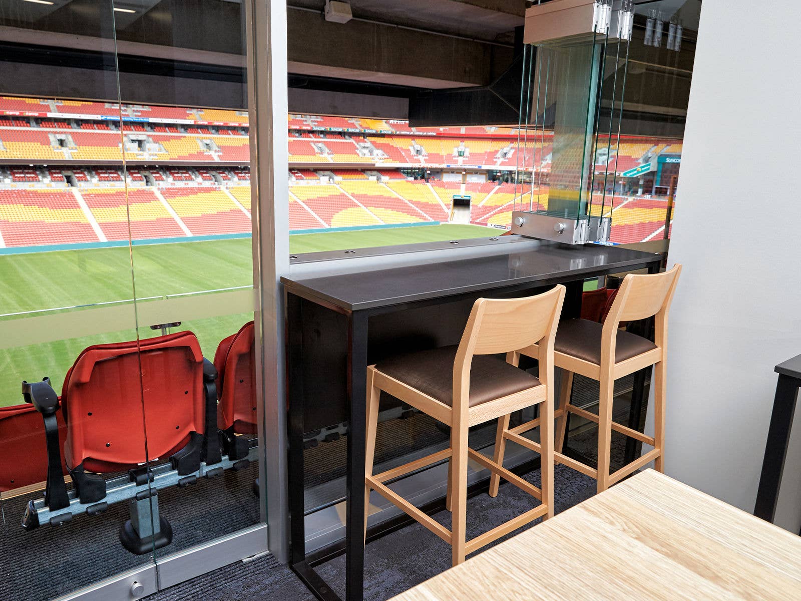 Inside a corporate suite at Suncorp Stadium with the field in the background