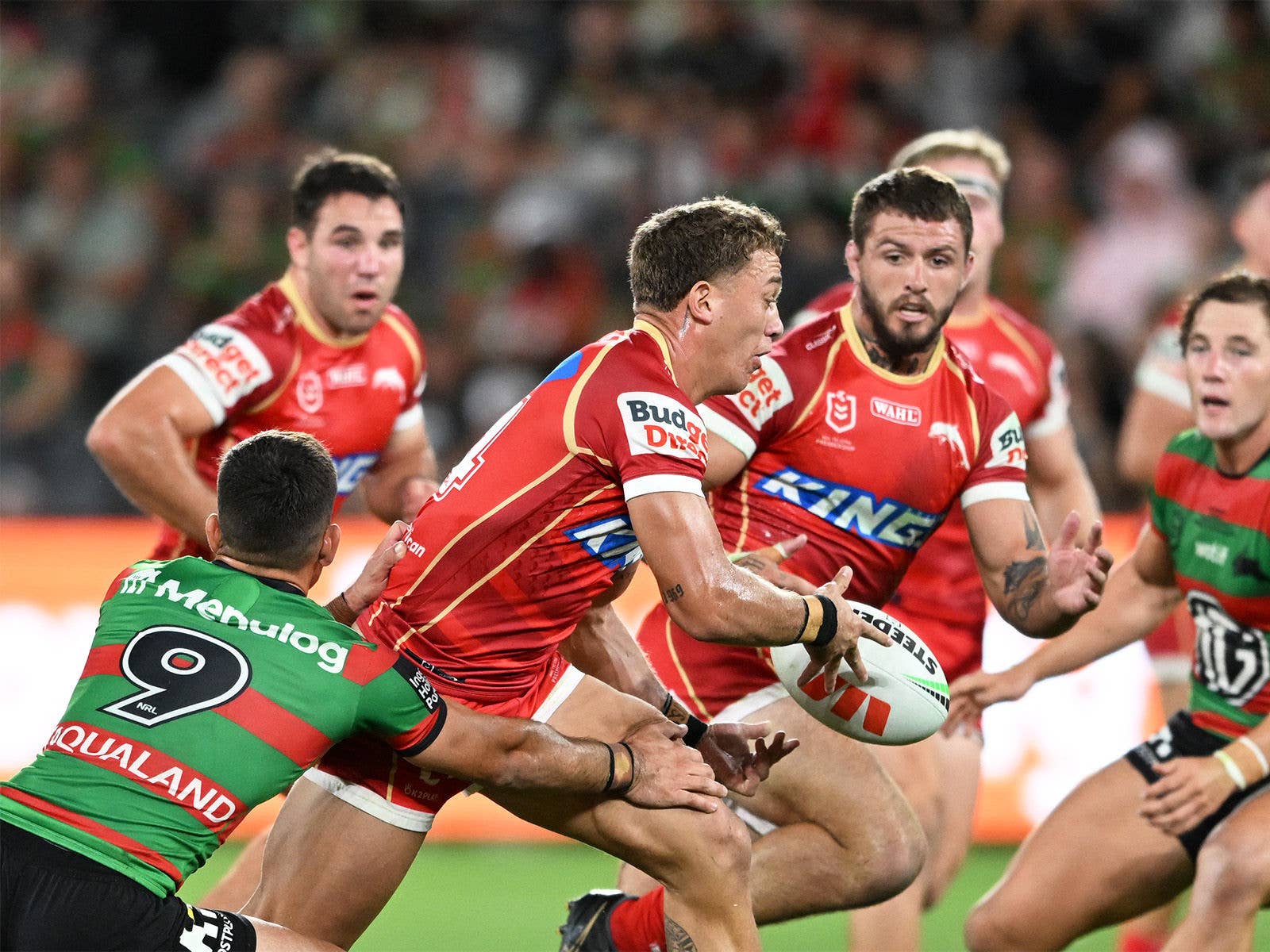 NRL Dolphins player passing the ball in a game against the South Sydney Rabbitohs