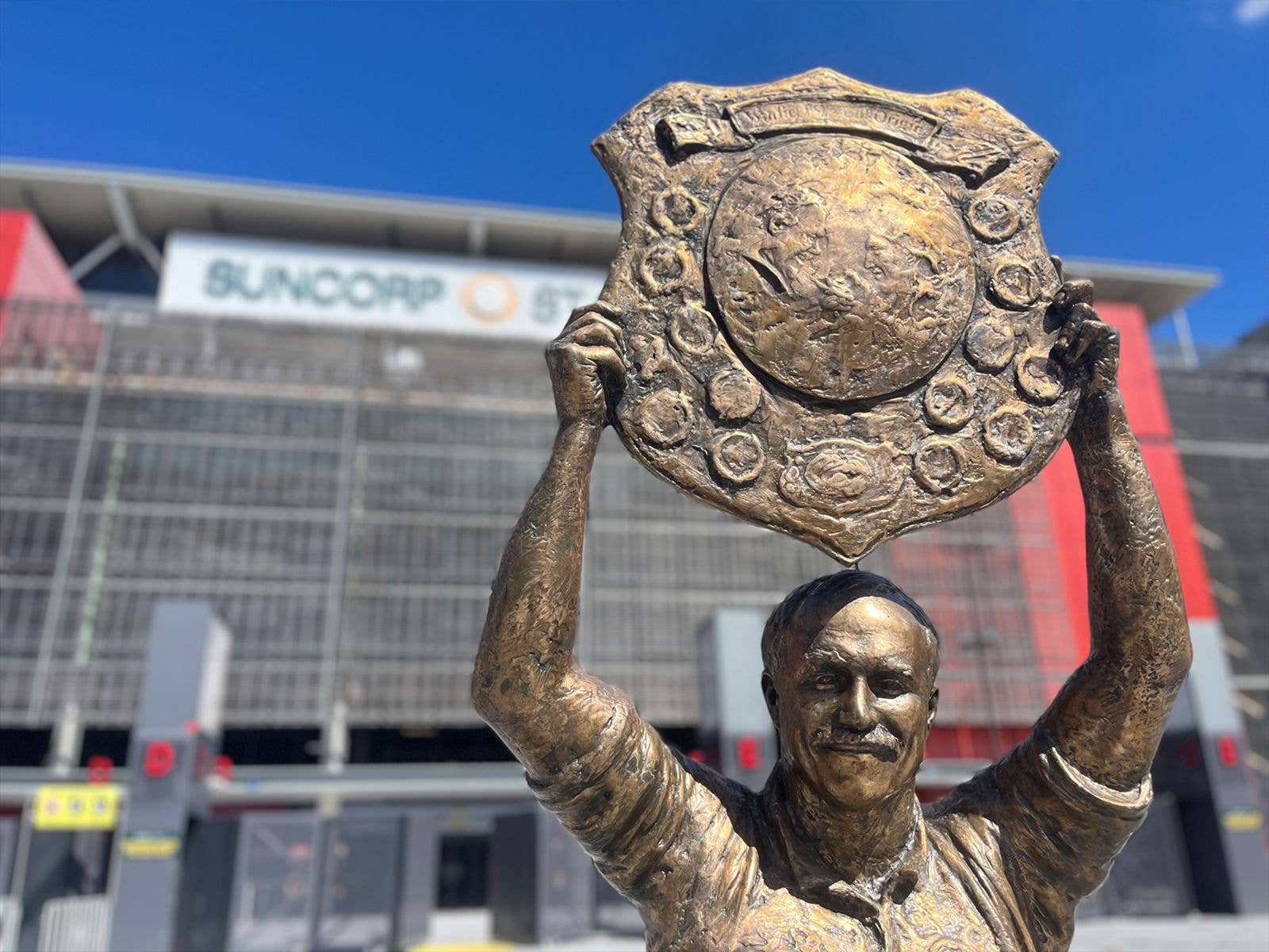 A close up of the top half of the Wally Lewis Statue in front of Suncorp Stadium