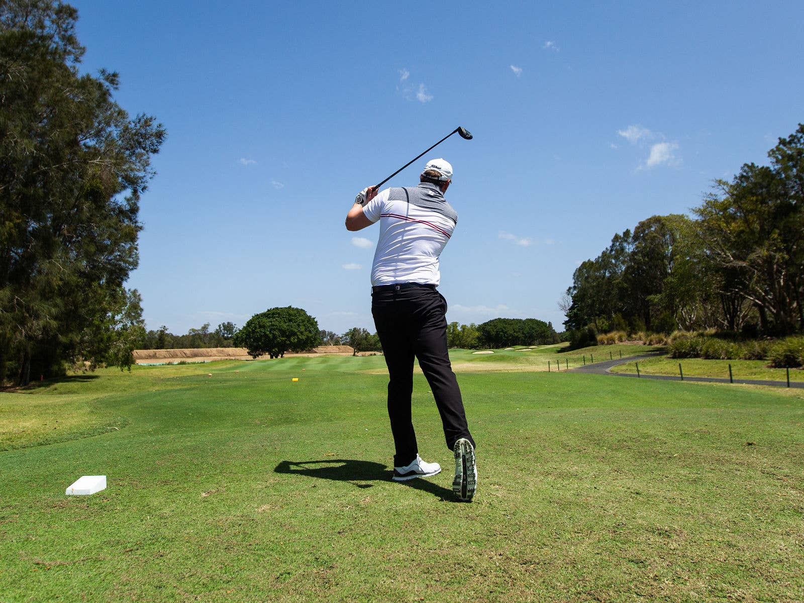 A golfer teeing off on the golf course