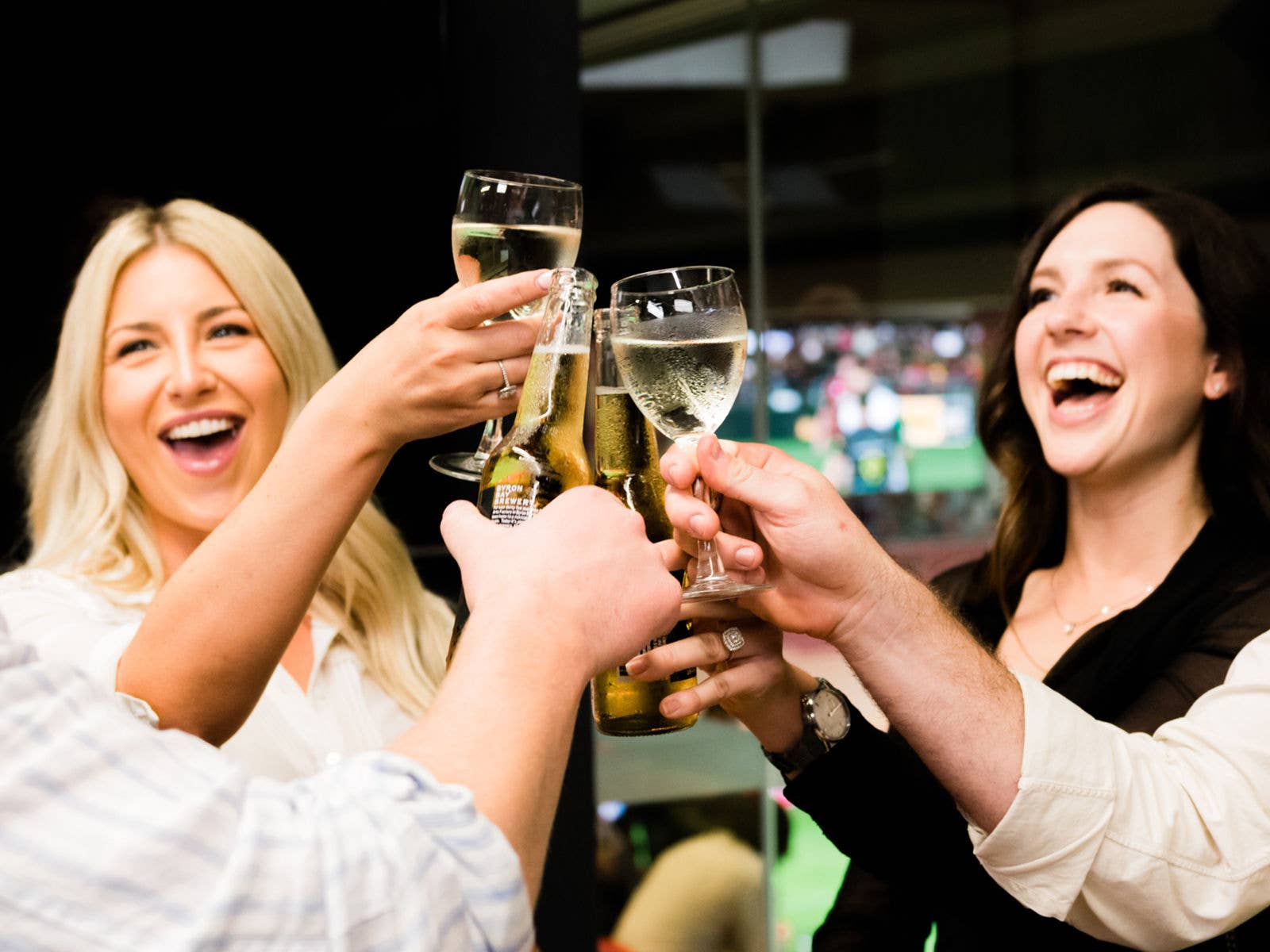 A group of people cheers with their wine glasses