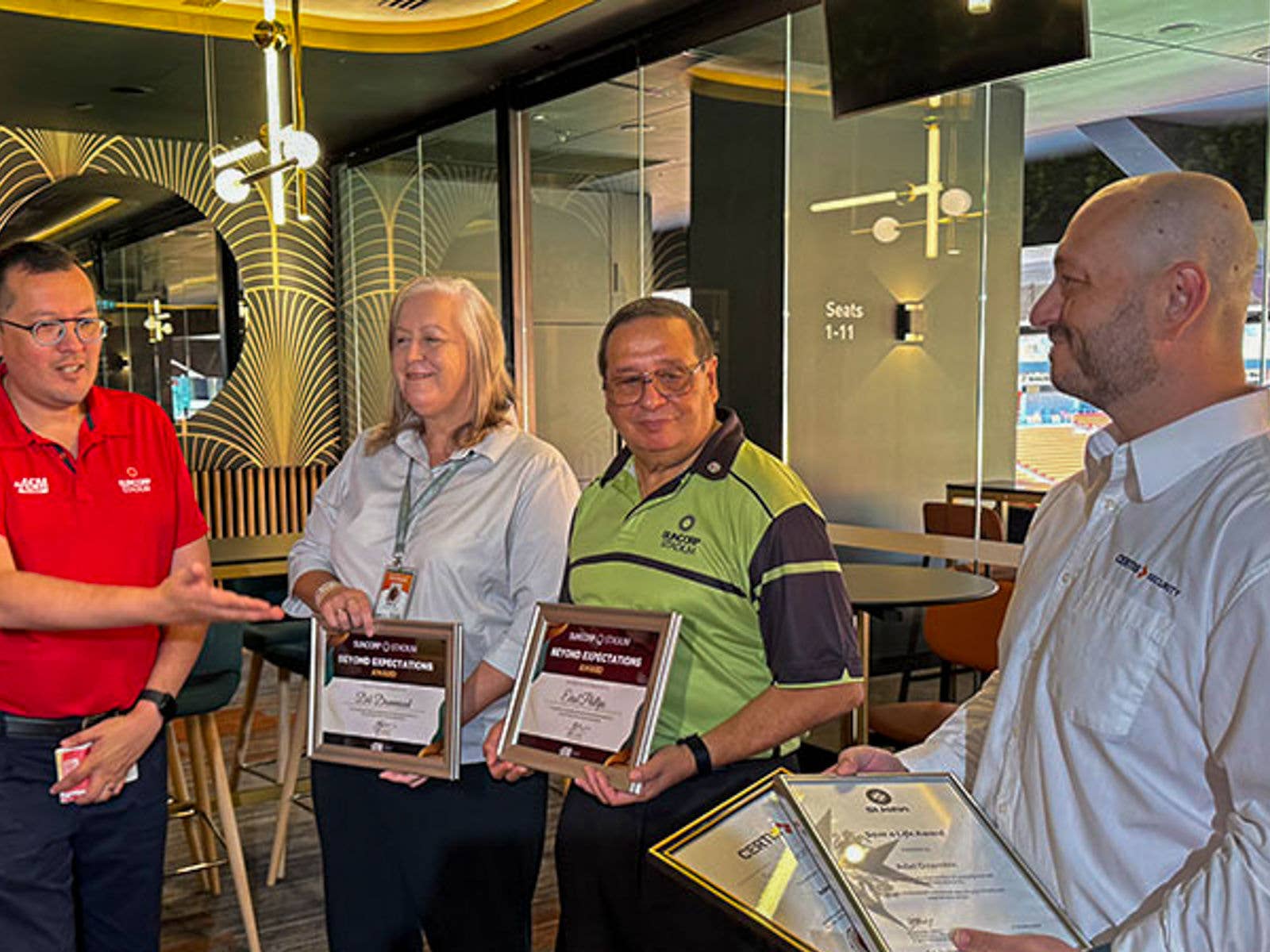 Suncorp Stadium Staff Saved A Life. Image of Graeme Kan (Far Left) presenting certificates to Stand Manager Deb (Left), staff member Errol (Right) and Certis Security Officer Adel (Far Right).