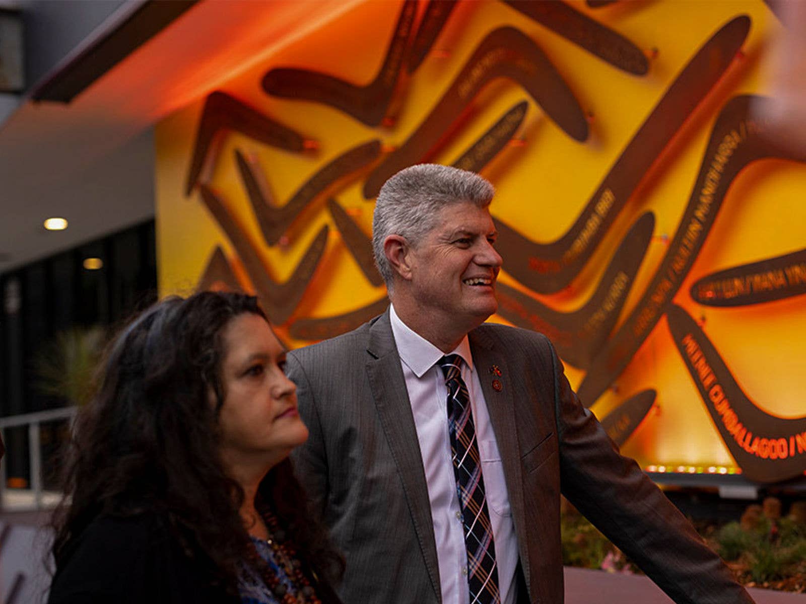 Artist and Sports Minister stood in front of 'Welcome' artwork. Artist and Sports Minister stood in front of 'Welcome' artwork.