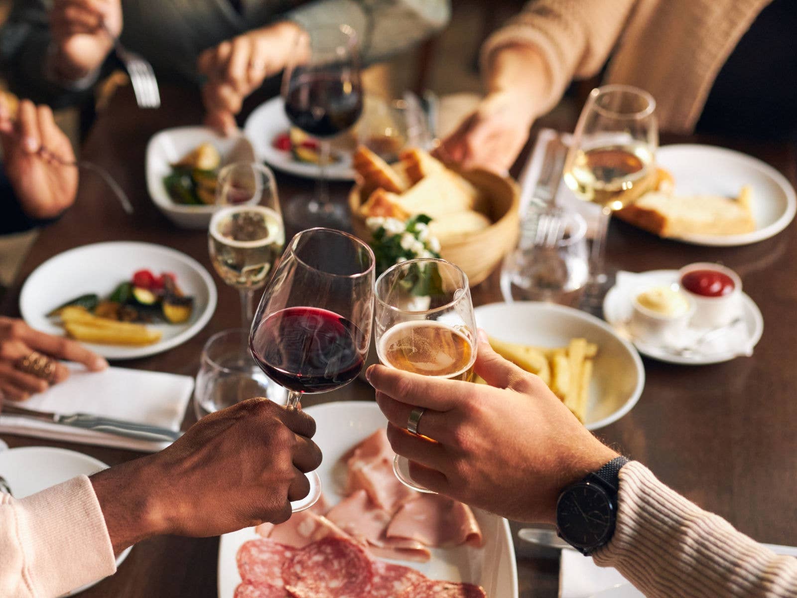 People dining with platters and wine