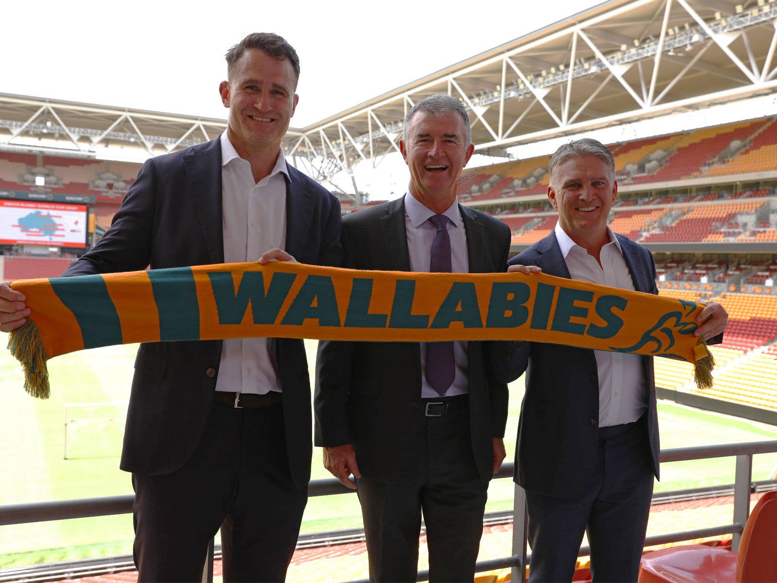 James Horwill Sports Minister Tim Mander and Tim Horan with a Wallabies Scarf at Suncorp Stadium