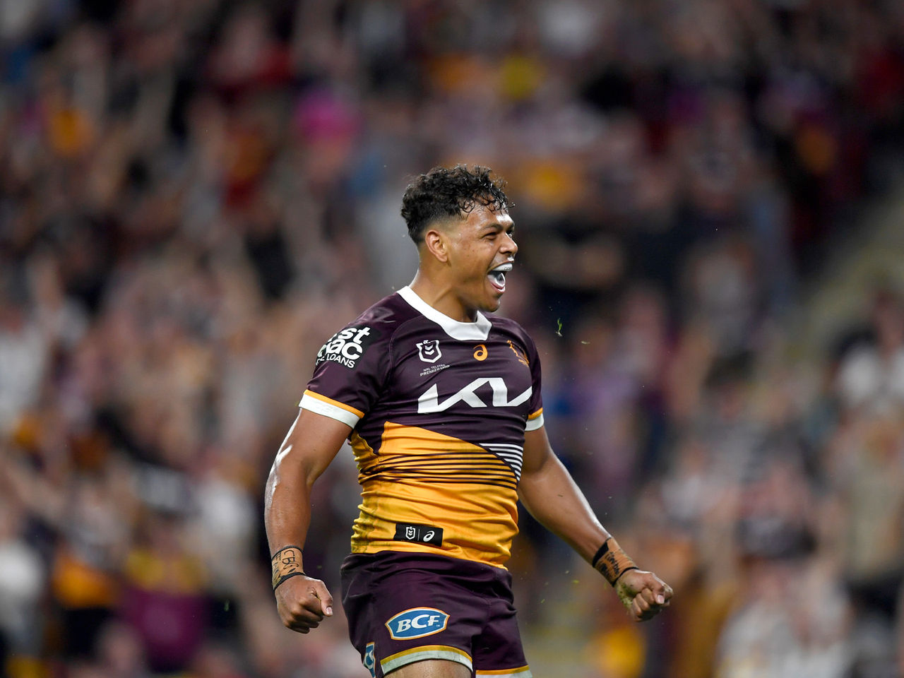 Broncos winger Selwyn Cobbo celebrating with a big smile scoring a try 