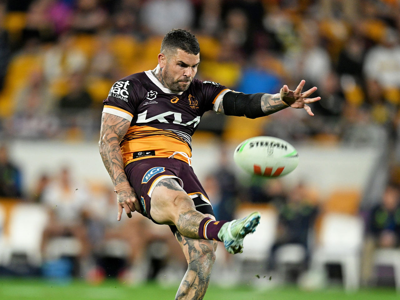 Broncos player Adam Reynolds kicking the ball 