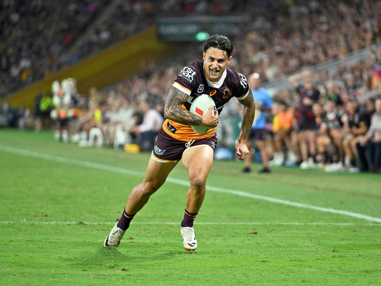 Broncos Player Jesse Arthurs running with the ball towards the try line at Suncorp Stadium