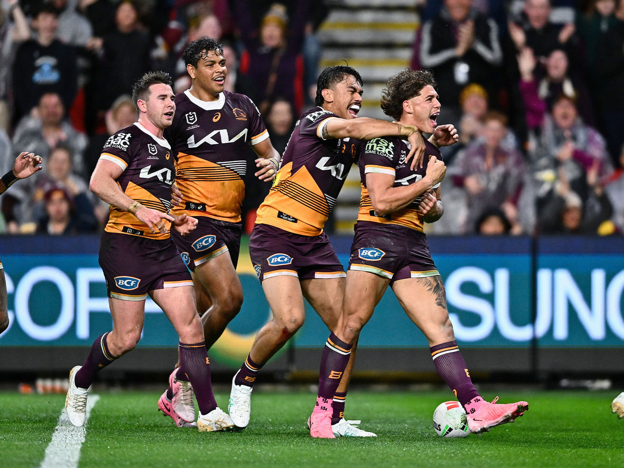 Broncos players celebrate Reece Walsh scoring a try