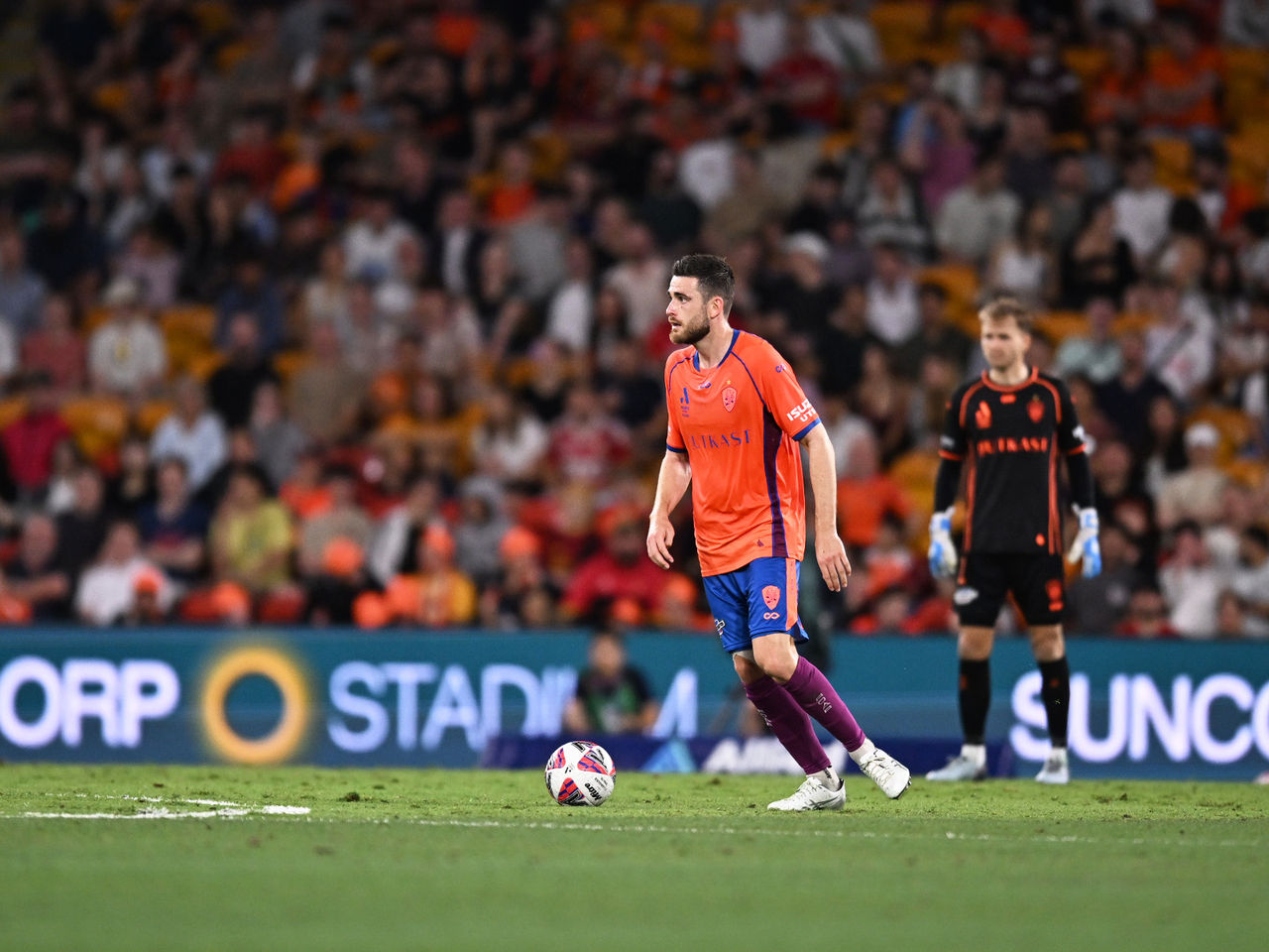 Brisbane Roar player about to kick the ball during a game at Suncorp Stadium