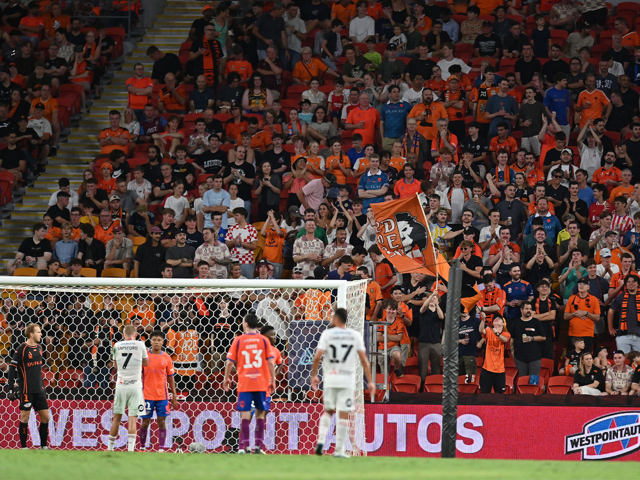 The Brisbane Roar ready for a cross with the Den supporters in the background