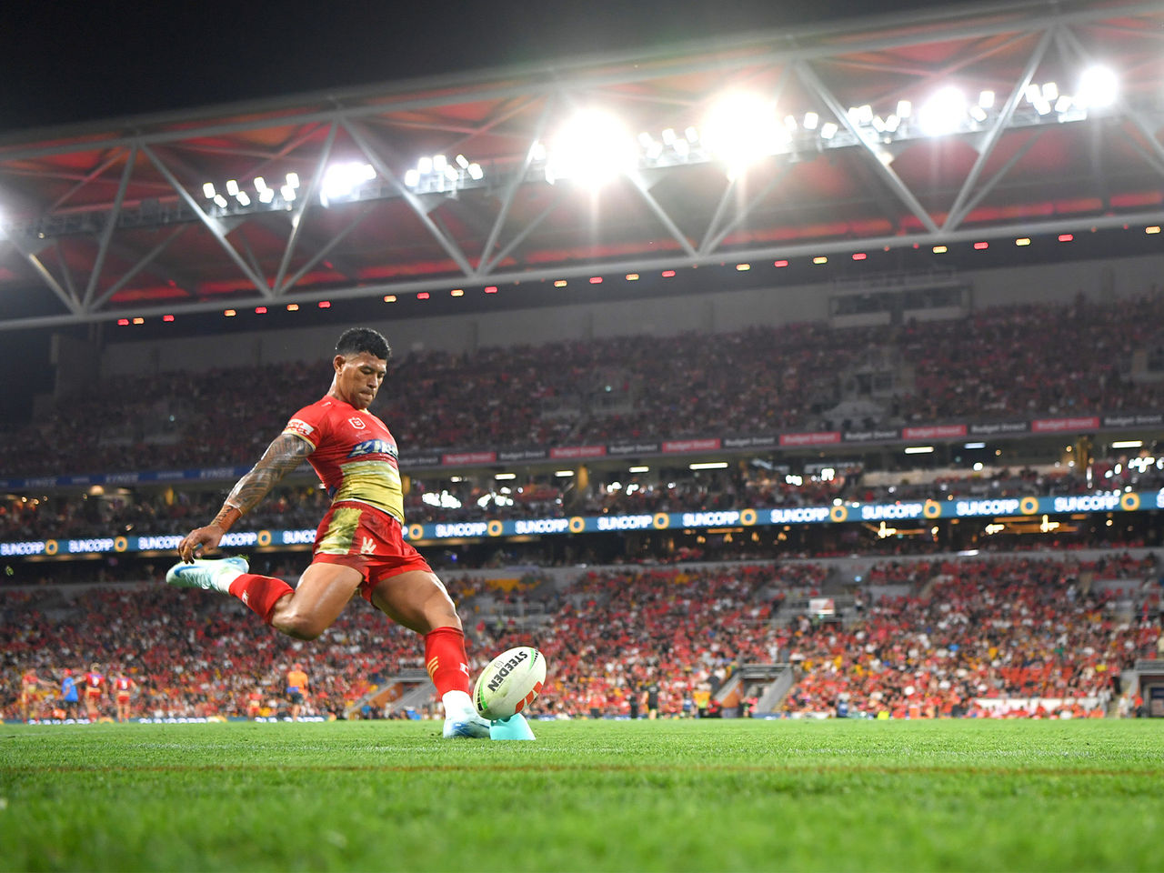 Dolphins player Jamayne Isaako taking a goal kick in front of a full Suncorp Stadium crowd 