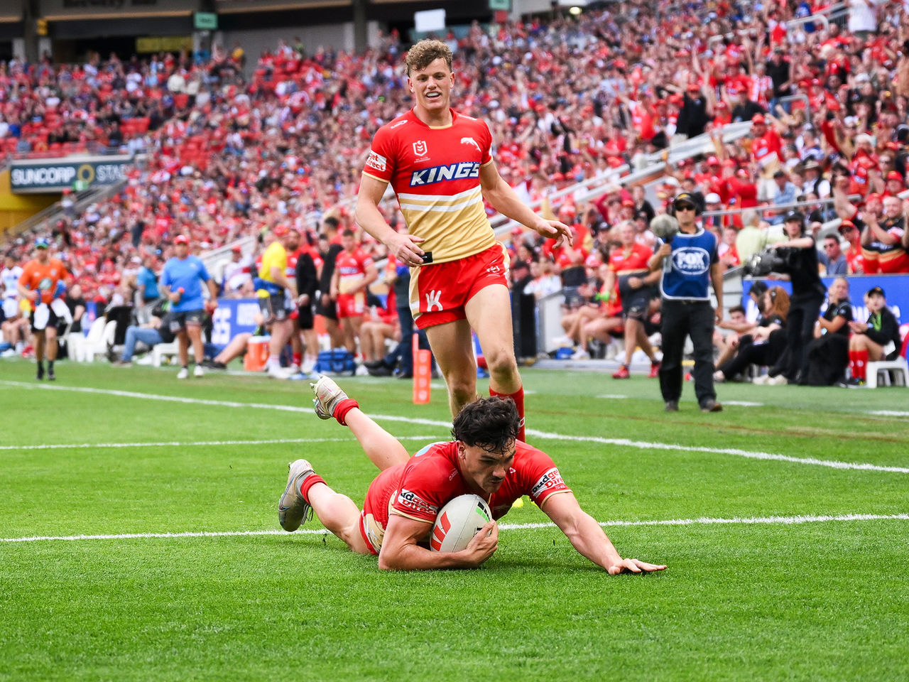 Dolphins player Herbie Farworth diving over the line and scoring a try in front of a full Suncorp Stadium crowd