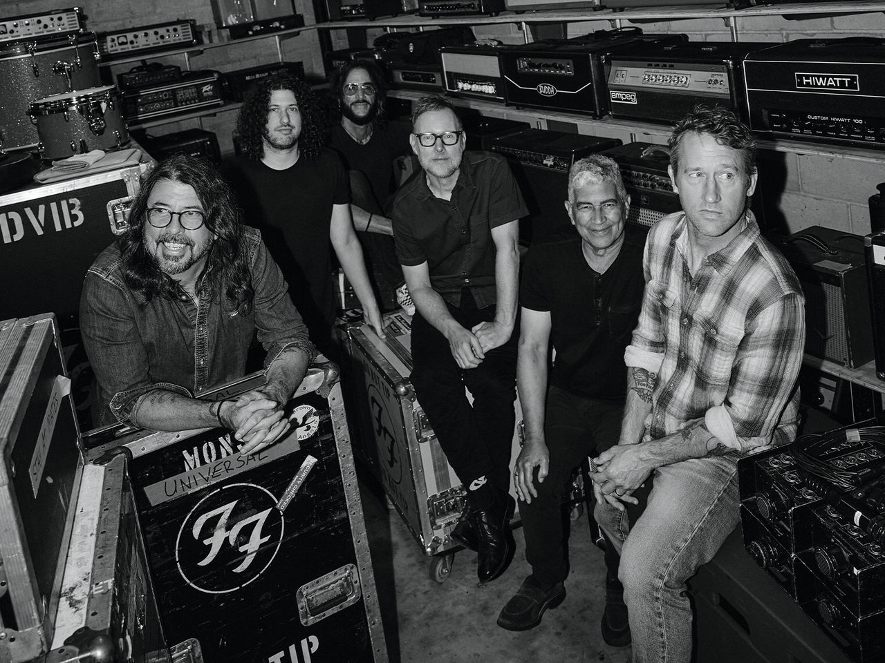 Foo Fighters Black and White Image of the band sitting down and smiling