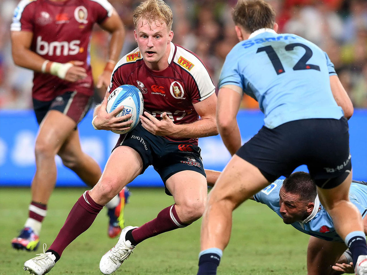 Tom Lynagh frm the Queensland Reds stepping towards a NSW player