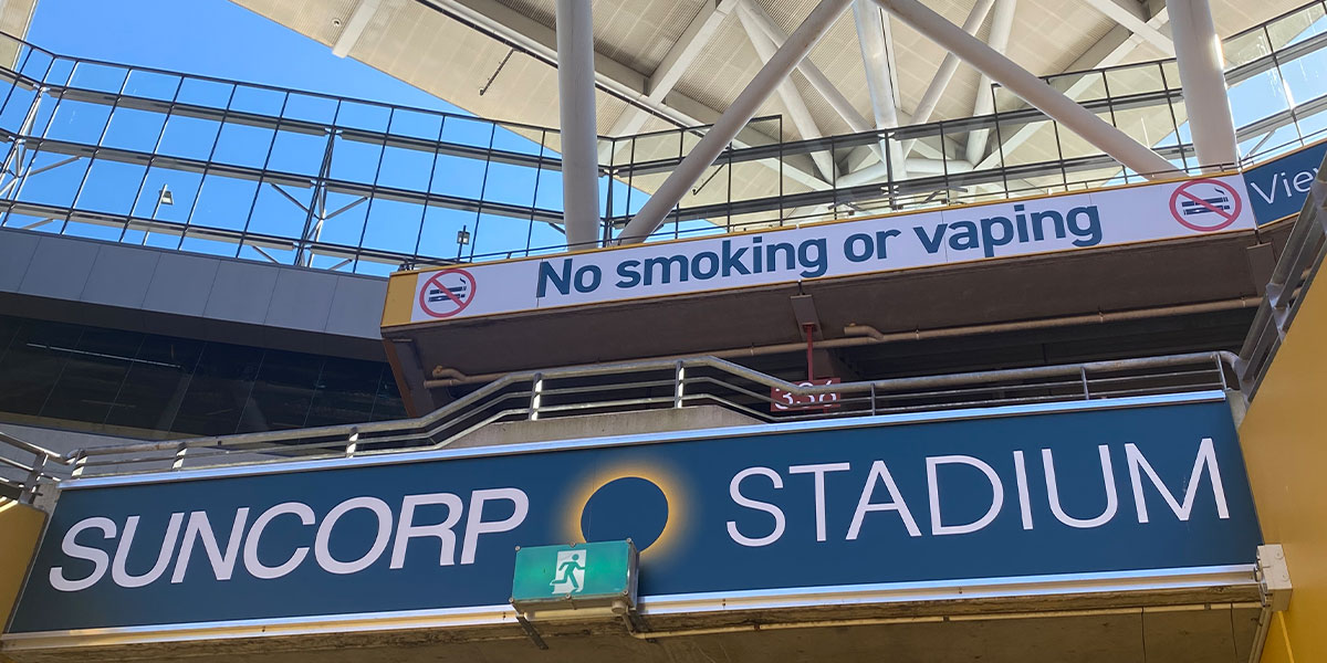 image of suncorp stadium signage and no smoking no vaping sign
