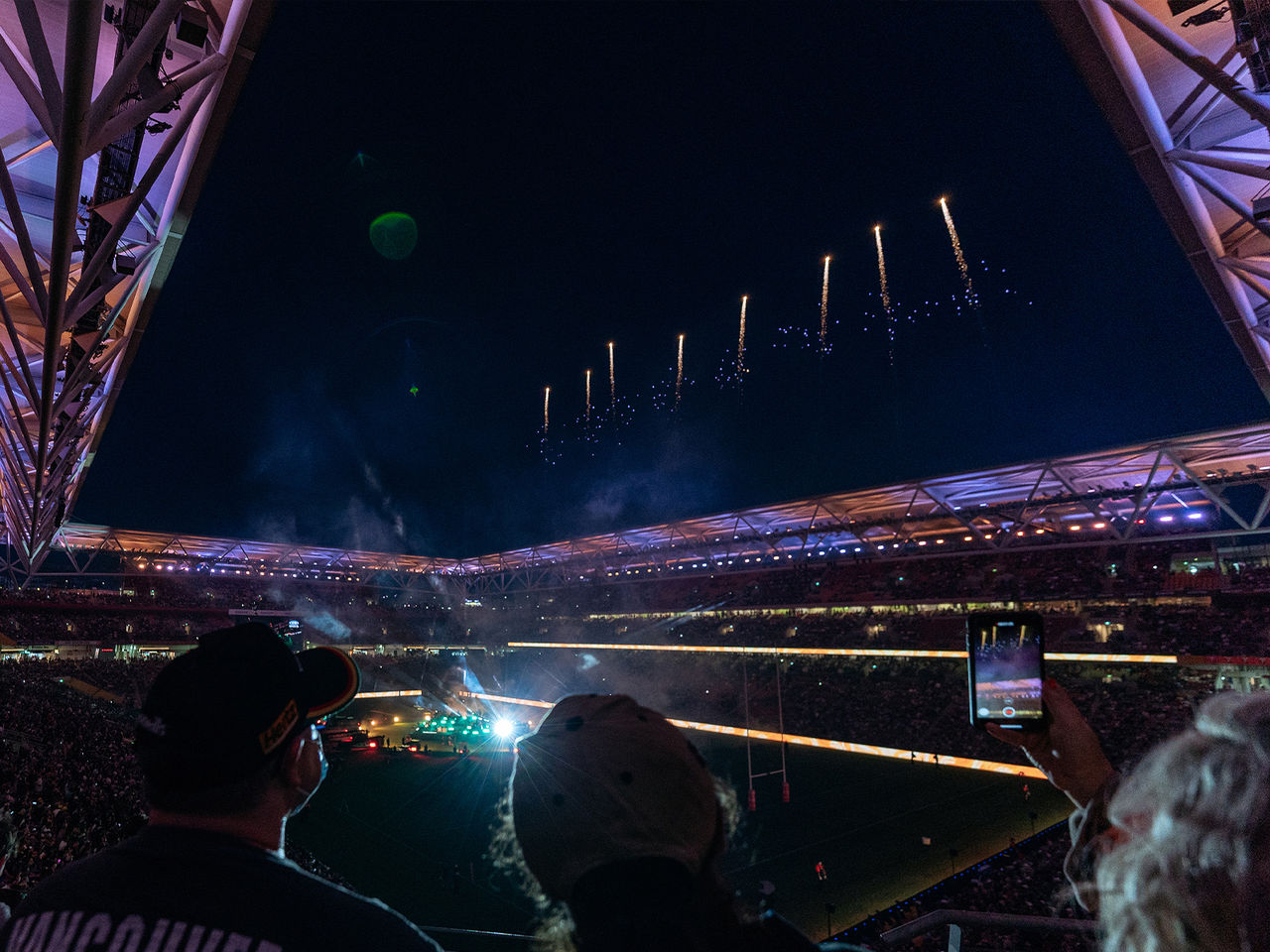 Suncorp Stadium lit up at night from inside before an event